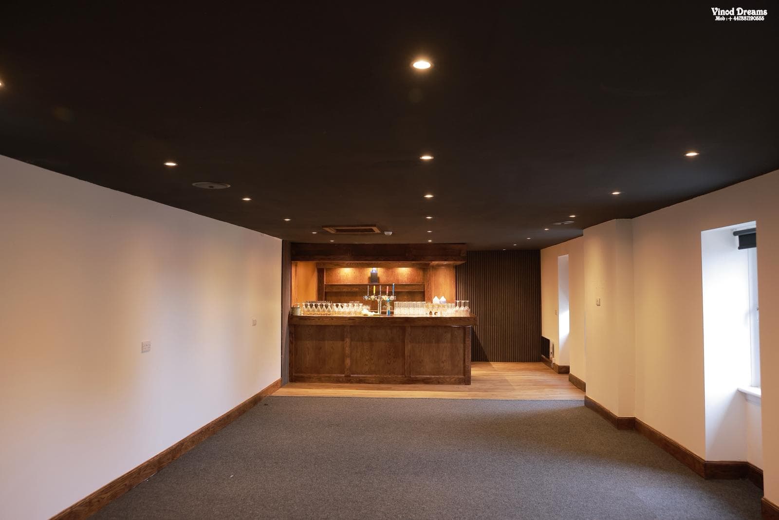 The private hall at Malabar Coast with an open floor and built-in wooden bar